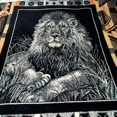 Descripción de foto - Cobertor de empresa San Marcos con una estampa de león en colo blanco y de fondo negro. - Crédito de foto - @yesijim35 - instagram