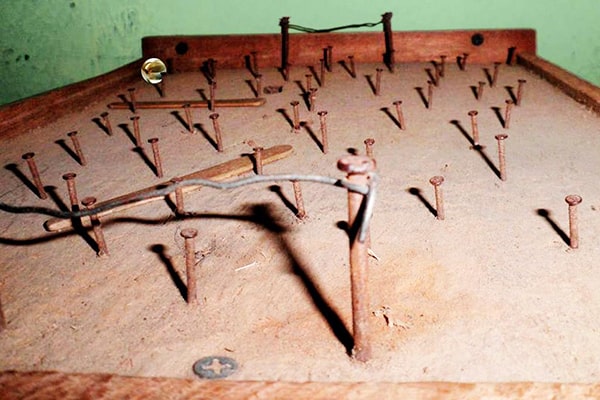 Descripción de foto - futillo con clavos puestos, con una canica en el fondo. - Crédito de foto - Bruno Besamusca